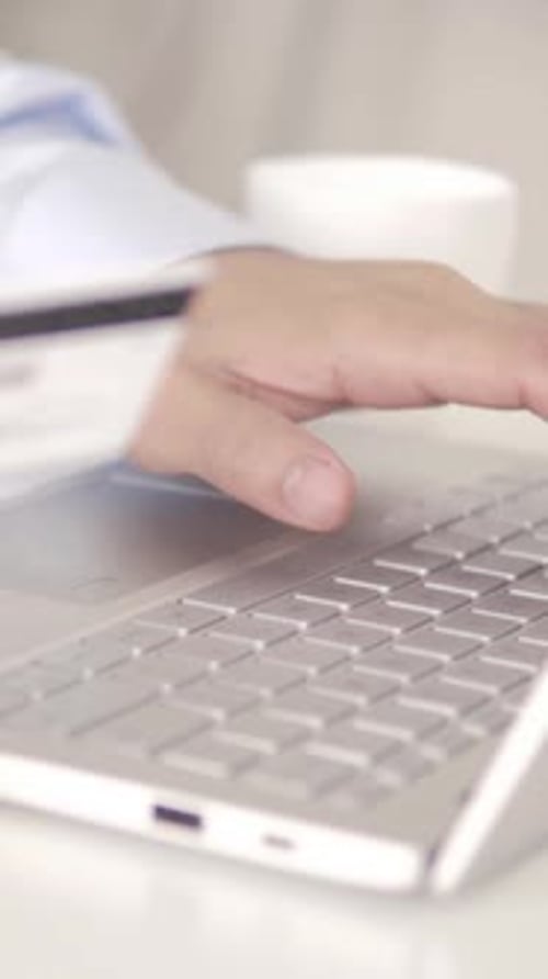 Typing on Laptop with Credit Card and Coffee