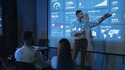 Man Presents Business Data at Office Meeting