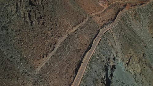 Motorcyclists are Driving on a Mountain Road Drone View