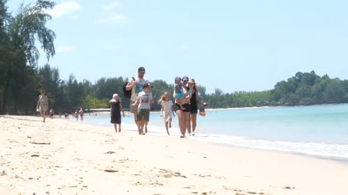 Family with kids walking along beach, Carry child, Togetherness concept