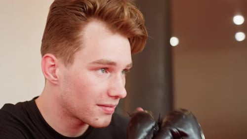 Male Fighter in Boxing Gloves Resting After Training Close Up Face Expression