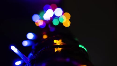 Close Up of Stairs Bannister with Multi Colored Lights Wrapped Around with Nice Aesthetic Bokeh