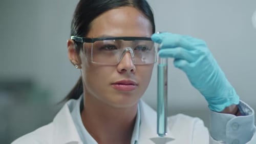 Young Woman Examining Test Tube in Laboratory