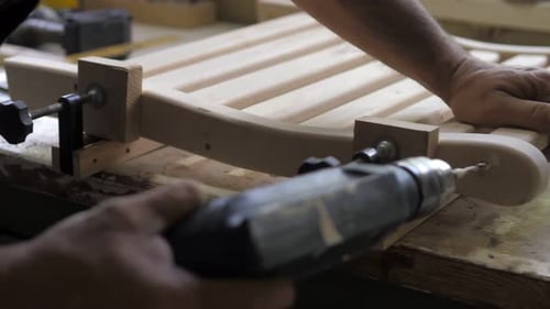 A Carpenter in the Workshop Lubricates Furniture Parts with Glue in the Workshop