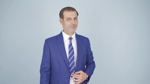 Confident Man in Blue Suit Adjusts Jacket