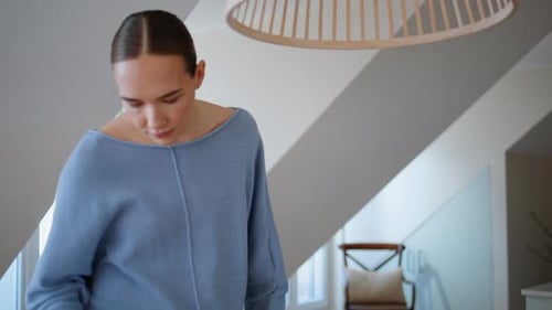 Woman Drinking and Working at Home on Laptop