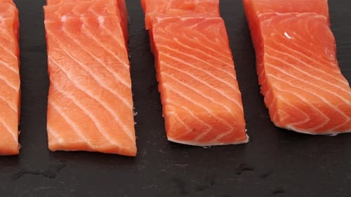 Raw Salmon Fillets Close Up on Slate Plate