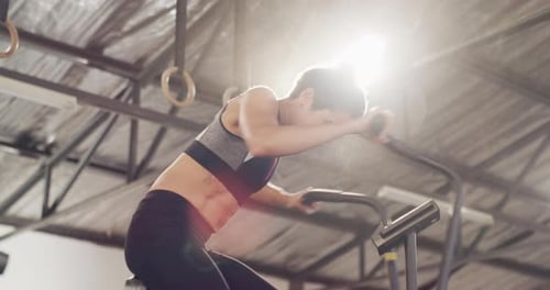 4k video footage of an attractive young woman working out on an elliptical machine in the gym