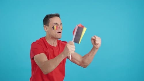 Man Cheering and Waving Flag in Studio