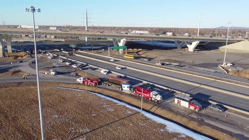 Aerial View Of Fallen cargo container recovery operation after rollover near exit ramp from the Cham