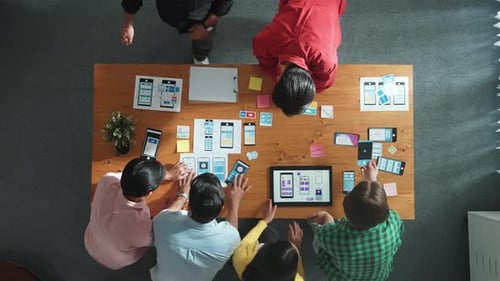 Team Collaborates on App Design at Table, Birdseye View