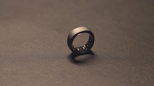 Modern Smart Ring Laying on Dark Surface