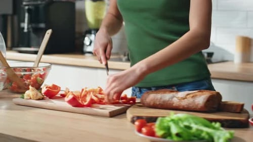 Woman Cutting Vegetables and Dancing in Kitchen