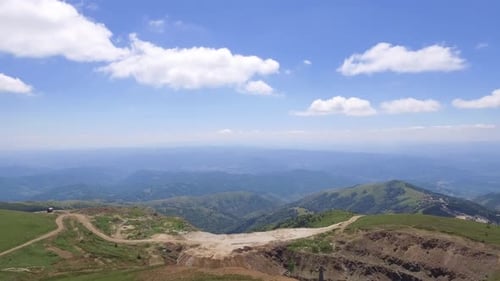 Lush Green Mountains and Rolling Hills Aerial View