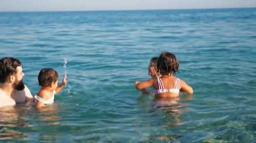 Family Fun in the Ocean Water on Sunny Day