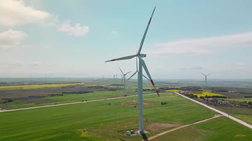 Wind Turbines Rotating in Rural Green Field