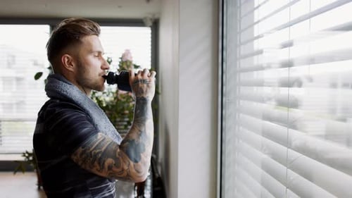 Man Drinking Water after Workout at Home