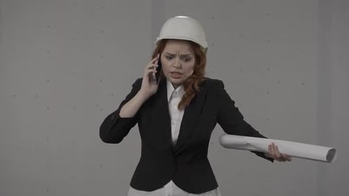 Worried Woman Architect Answers Call on Mobile Phone