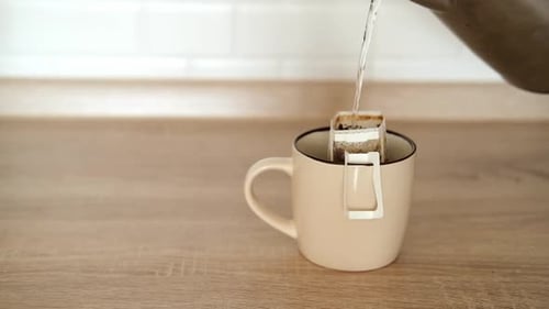 Pouring Water Into Coffee Filter in Mug