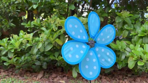 Blue pinwheel barely spinning from light wind breeze, close up
