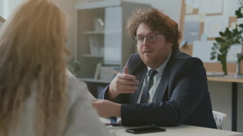 Businessman Presenting Document during Office Meeting with Client