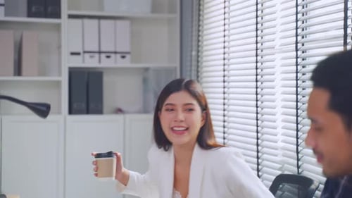 Young attractive businessman and businesswoman work in office workplace.