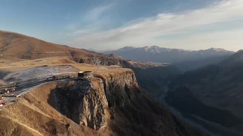 Russia-Georgia Friendship Arch on Jvari Pass in Gudauri Mountains at Sunset.