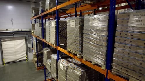 Produits étiquetés emballés sur des étagères à plusieurs niveaux dans un entrepôt