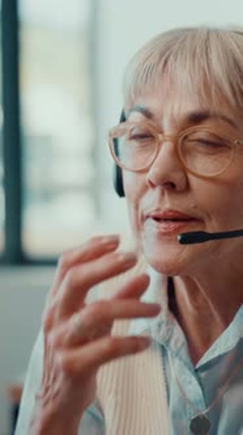 Mature woman, headset and customer service consultant in office with online consultation for crm