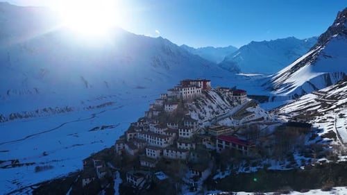 Aerial drone shot offering a sweeping view of Key Monastery and its snow-covered surroundings