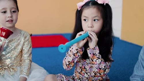 Children Playing Musical Instruments in School Classroom