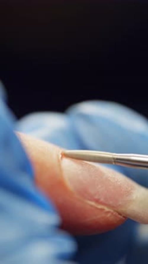 Closeup of Cuticle Removal Using a Manicure Machine
