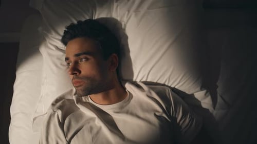 Sleepy Man Lying Bedroom at Night Closeup Top View Guy Resting on Home Pillow