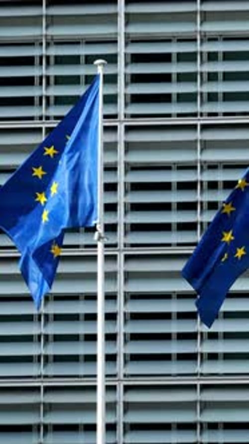European Union Flag Waving Against Building