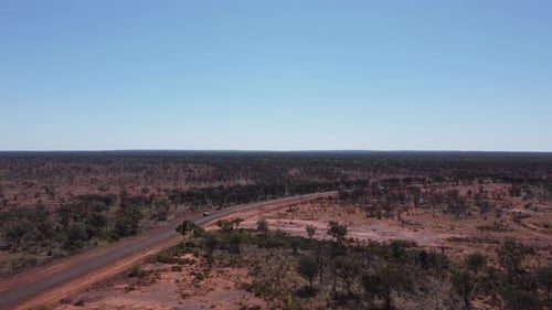 Drone flying towards a sealed country road in the Australian Outback