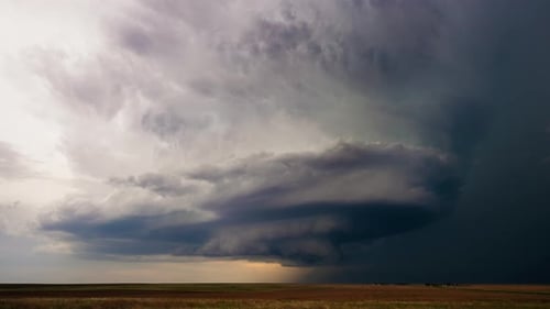 Dramatic Storm Clouds Over Expansive Rural Landscape