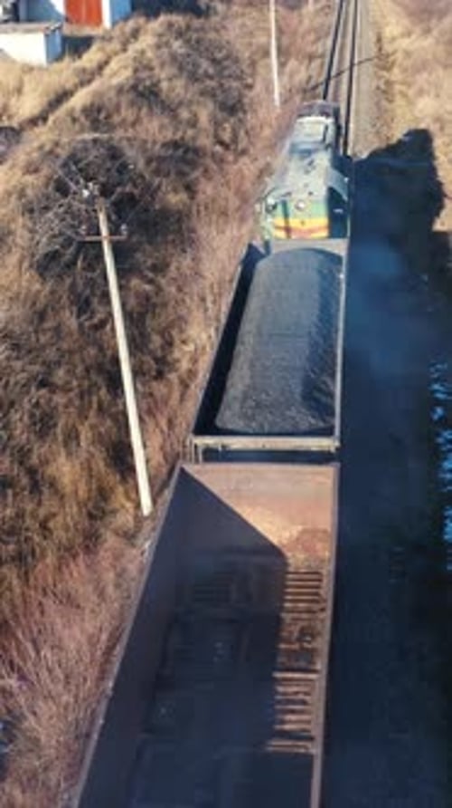 Freight train moving in winter. Top view on a cargo train on rails.