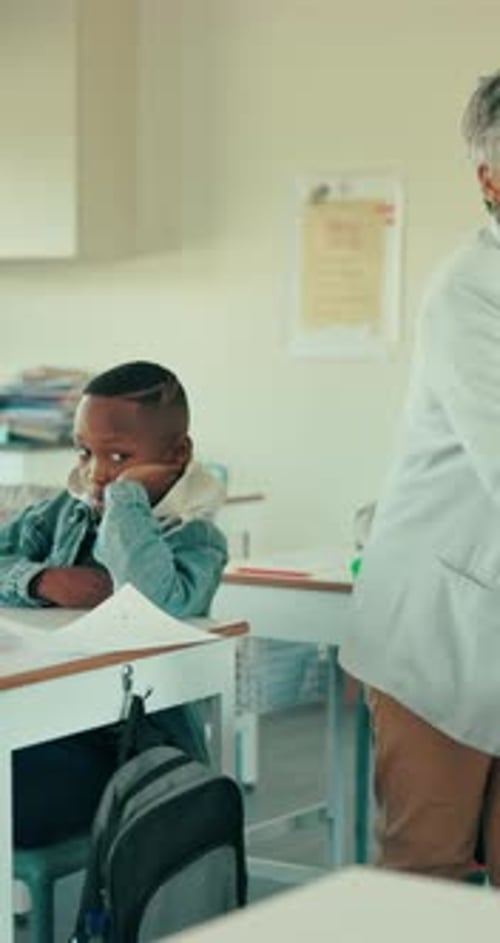 Teacher Helping Students in Classroom at School
