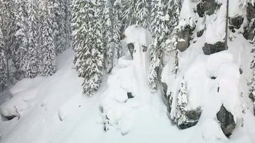 Skier Descends Snowy Mountain Slope in Winter