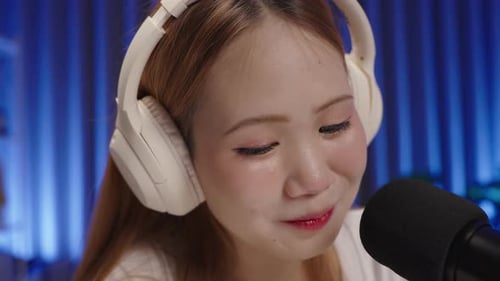 Woman Talking Into Microphone with Headphones On