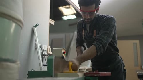 Carpenter is working at workshop.