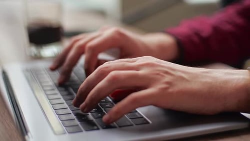 Close Up of Freelancer's Developer Hands Typing Program Code on Laptop Keyboard in Coworking