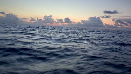 Dusk Over Open Ocean Dramatic Waves and Colorful Sunset Sky