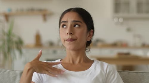 Woman Fanning Herself to Cool Down Indoors