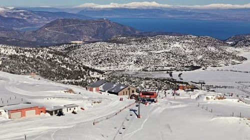 Ski Resort with Scenic Lake View and Snowy Mountain Landscape