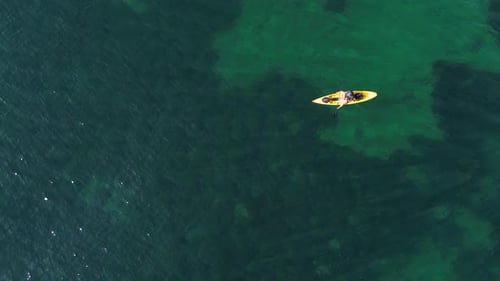 Aerial view of kayak fishing at seascape, trolling fishing drone view. Fisherman trolling in kayak