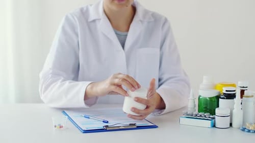 Female doctor prepares medication dose at hospital as per prescription