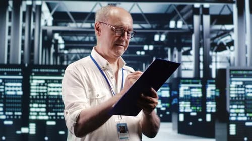 Technician Writes on Clipboard in Server Room