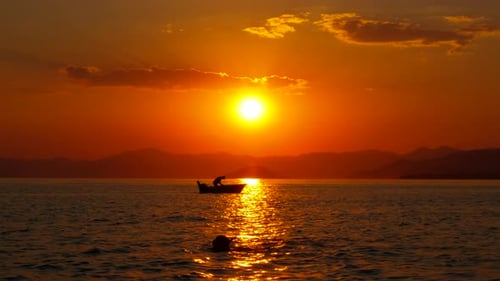 Sunset Silhouettes: Boat on the Ocean
