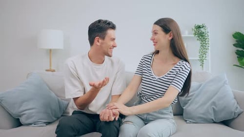 Loving Couple Smiling Together on Couch